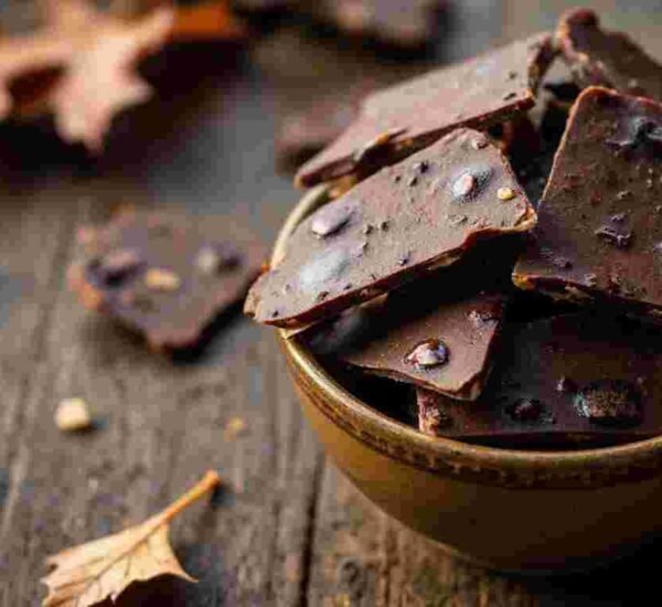 Pieces of homemade bonfire toffee in a white bowl.
